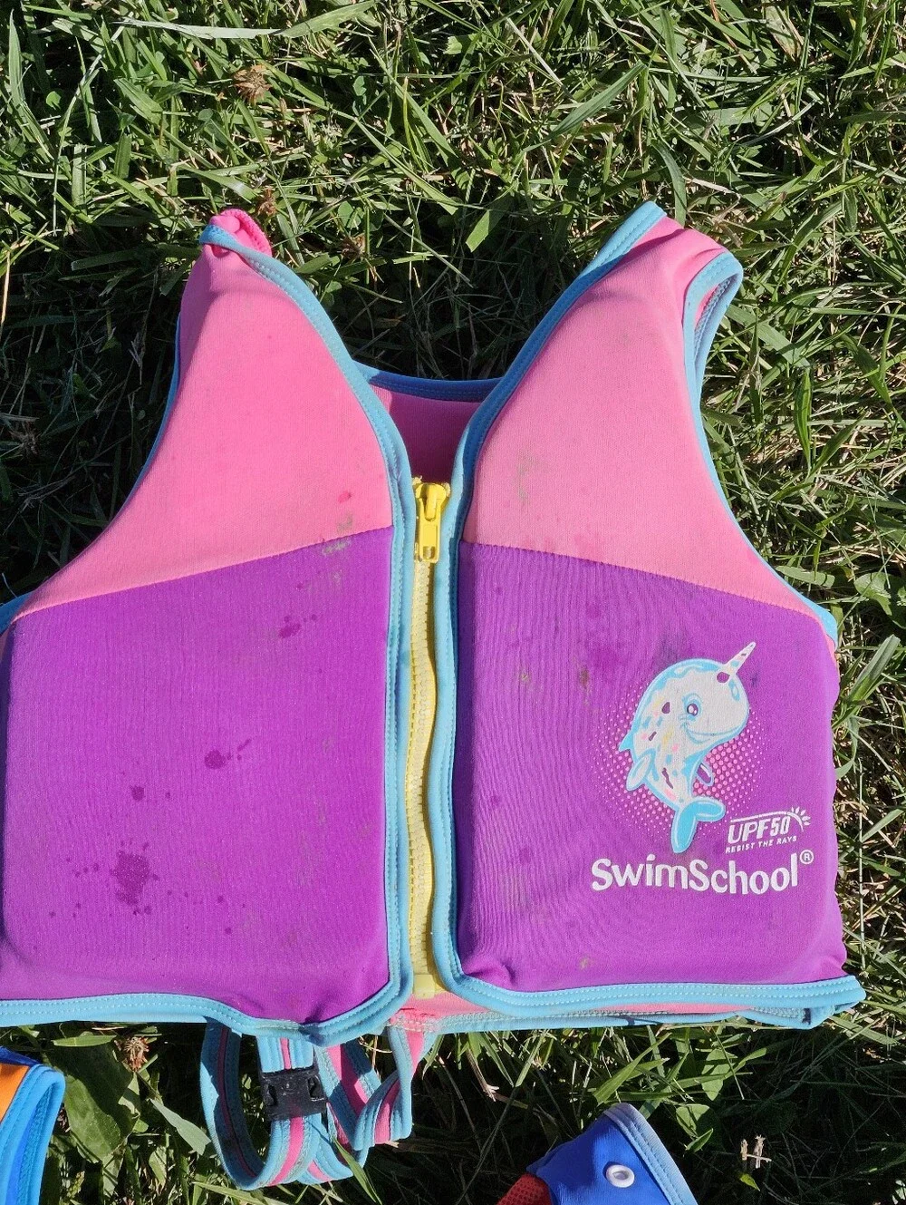SwimSchool kids life jackets in blue/orange with white chevron pattern and green
